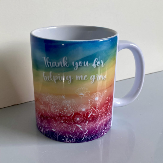 SUBLIMATED 'HELPING ME GROW' RAINBOW WITH FLOWERS MUG